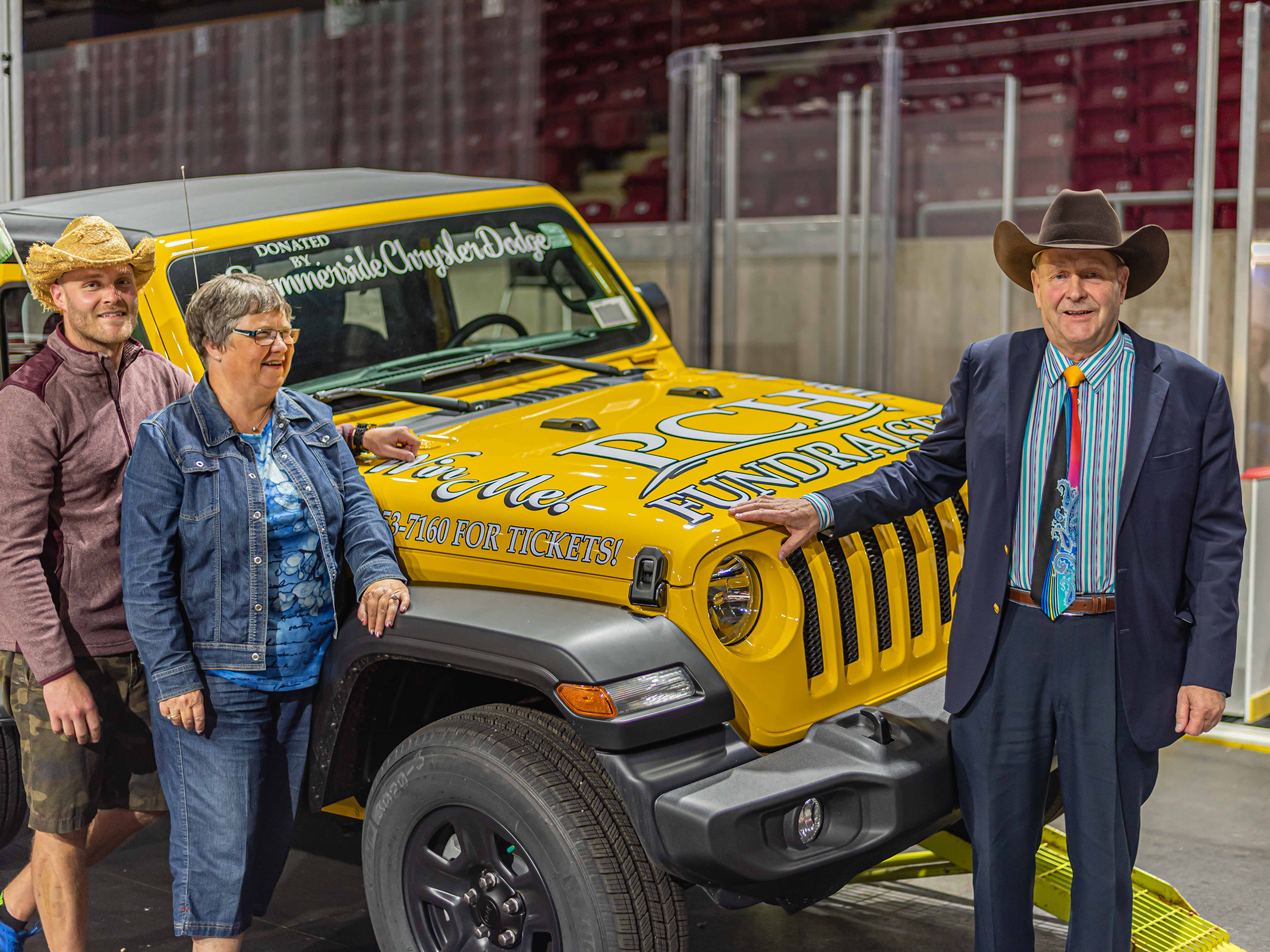 Yellow Jeep Wrangler with cowboys